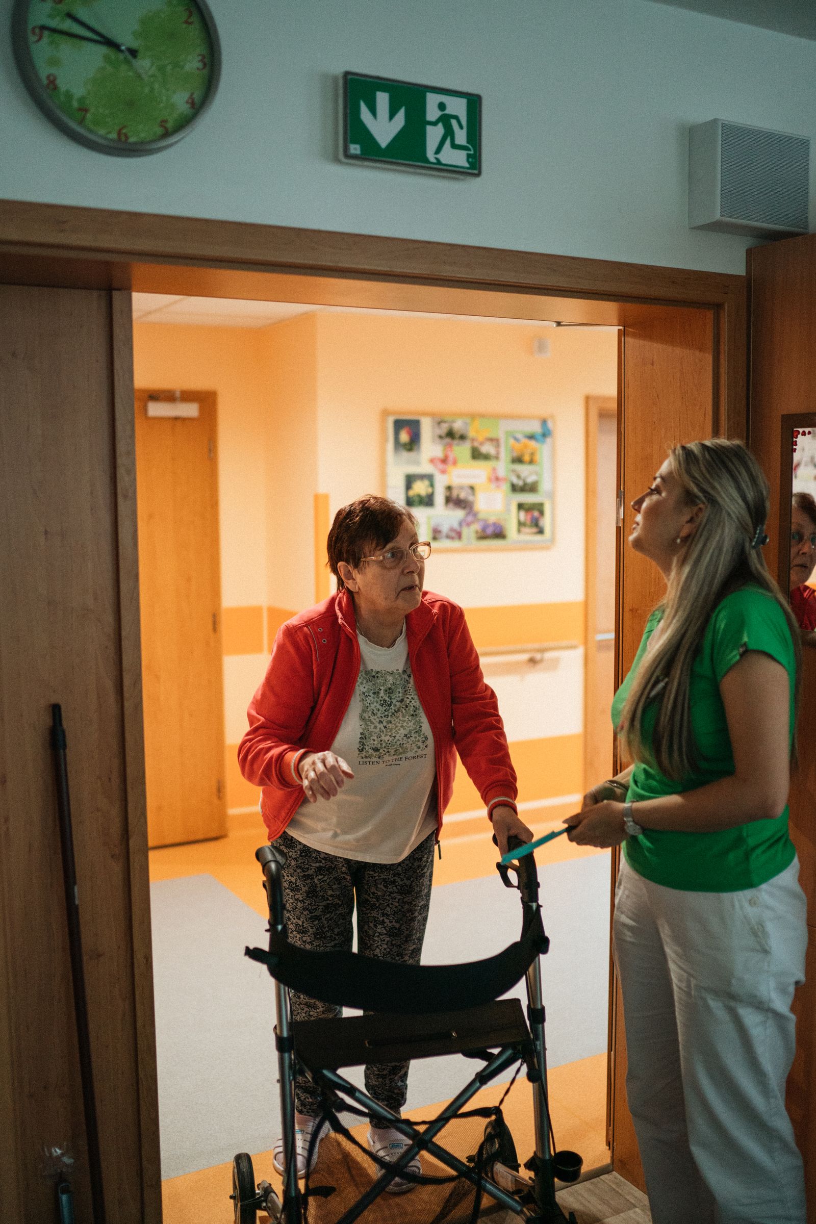 Caregiver supporting a senior on a garden walk